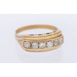 A diamond set six stone gold ring, comprising five diamonds and one replacement paste stone,