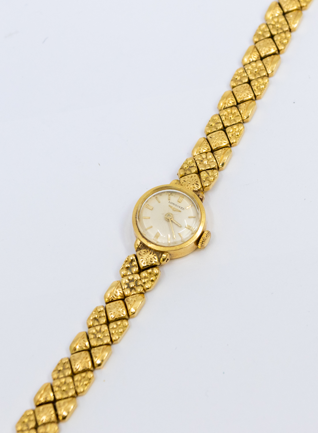 Longines- a ladies vintage18ct gold wristwatch, comprising a round signed silvered dial with applied