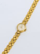 Longines- a ladies vintage18ct gold wristwatch, comprising a round signed silvered dial with applied