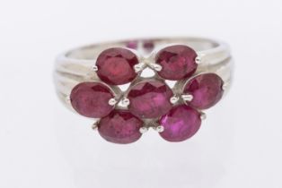 A ruby and 9ct white gold cluster ring, comprising seven oval mixed cut rubies, each approx 4x3mm,