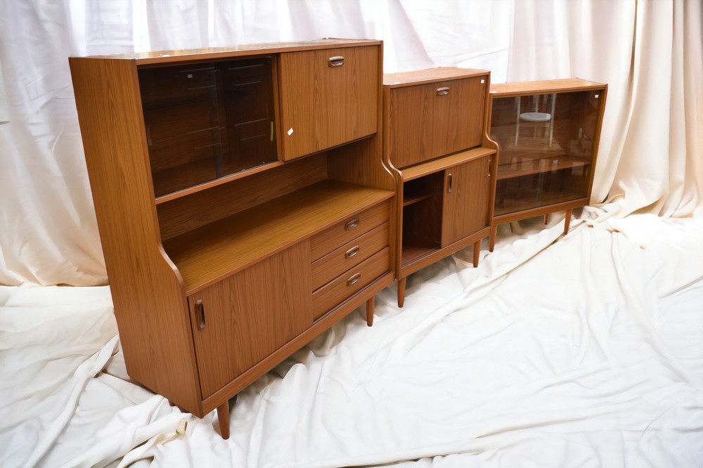 A collection of 1970s Schreiber teak-effect cabinets comprising drinks cabinet, bureau and a small