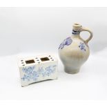 An 18th Century Delftware blue and white flower brick, crudely decorated with flowers, the