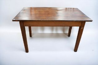 An early 20th Century solid oak kitchen table with planked top and thick tapered legs.