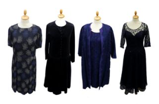 A navy viscose dress by Toast with a lighter blue and beige floral design on a navy background,