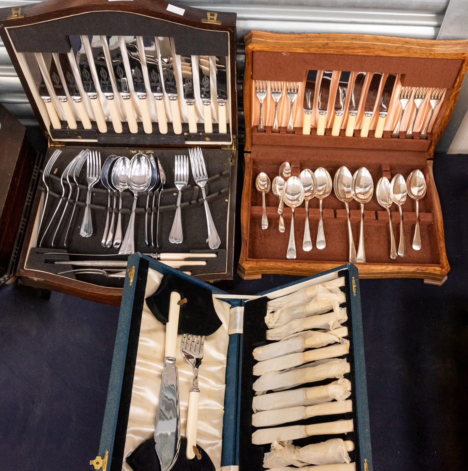 Three 20th Century canteens of cutlery, one chrome plated, others silver plate, two sets with