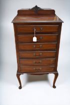 A set of modern mahogany music drawers, a modern mahogany desk with drawers and a modern writing