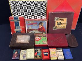 A collection of vintage board and card games including jigsaws.