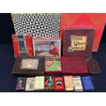 A collection of vintage board and card games including jigsaws.