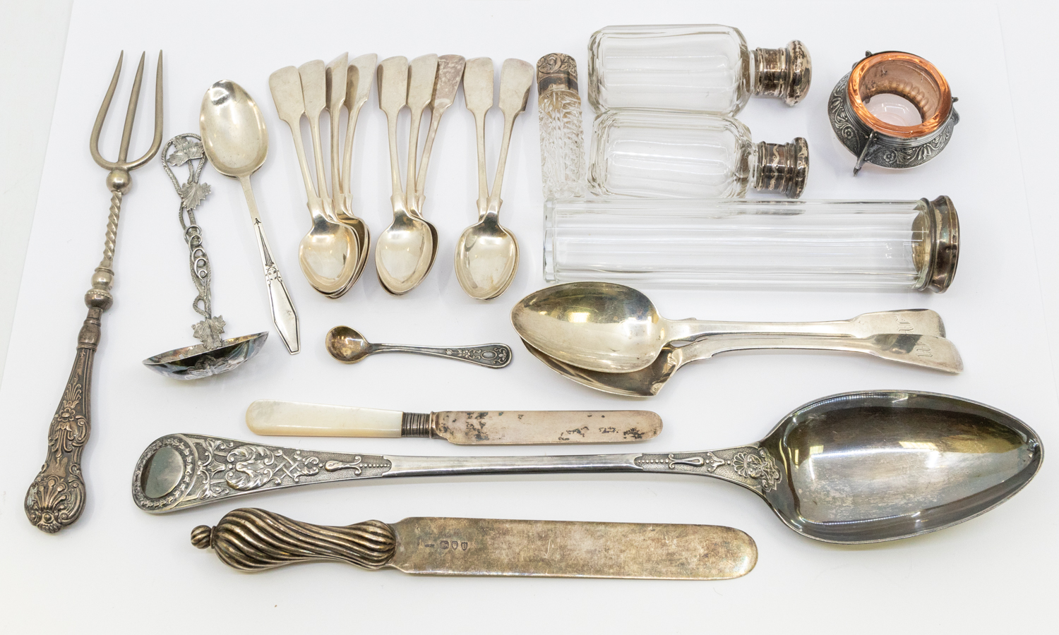 A mixed collection of silver and plated flatware to include; an ornate Victorian silver sifter