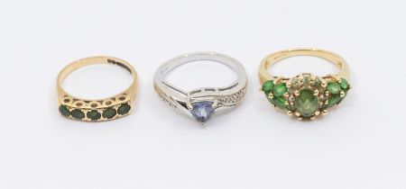 Three 9ct gold stone set rings, including a white gold and tanzanite trillion cut ring the shoulders