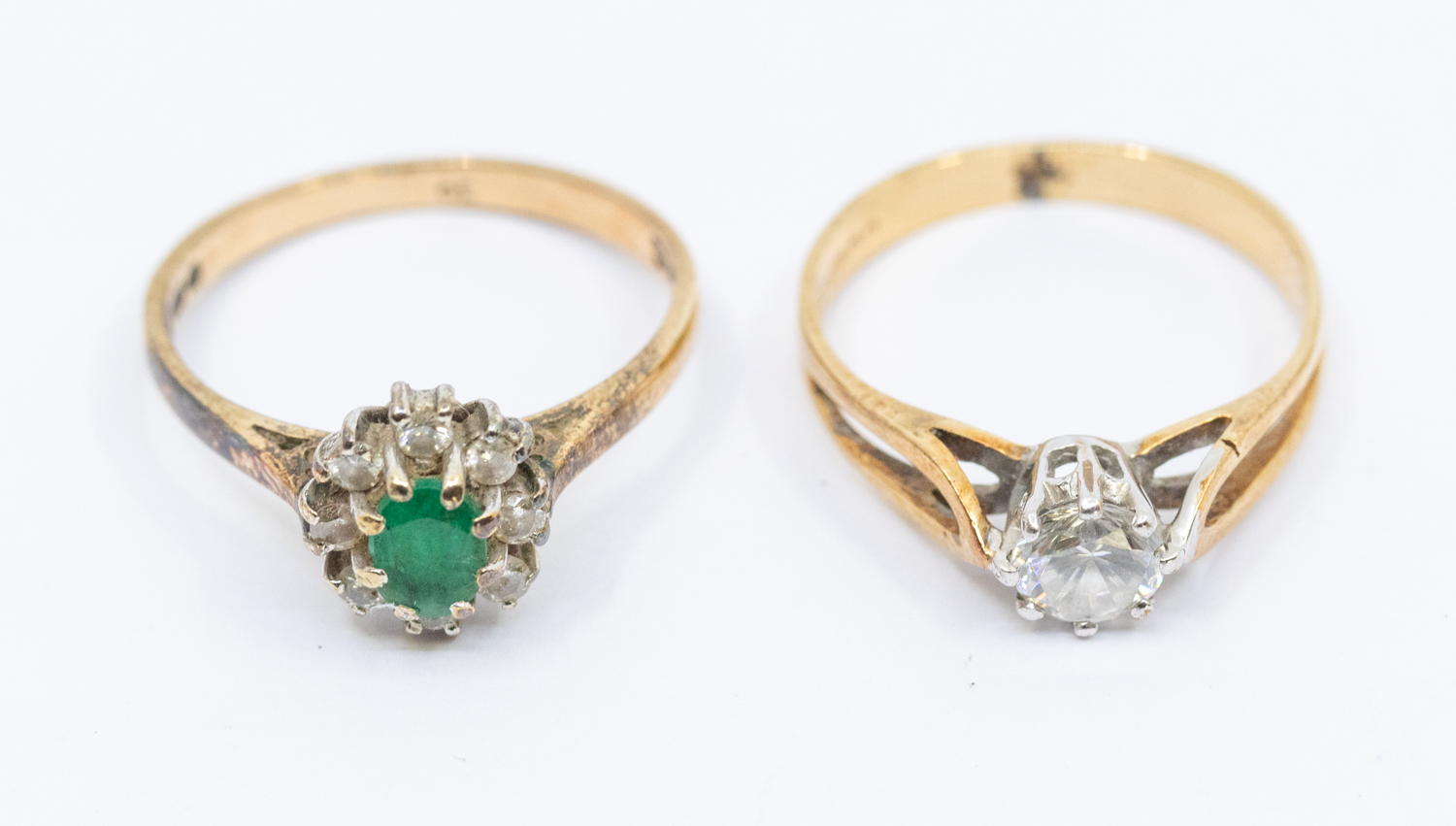 A 9ct gold emerald and diamond cluster ring, size M1/2, along with 9ct gold cubic zirconia set