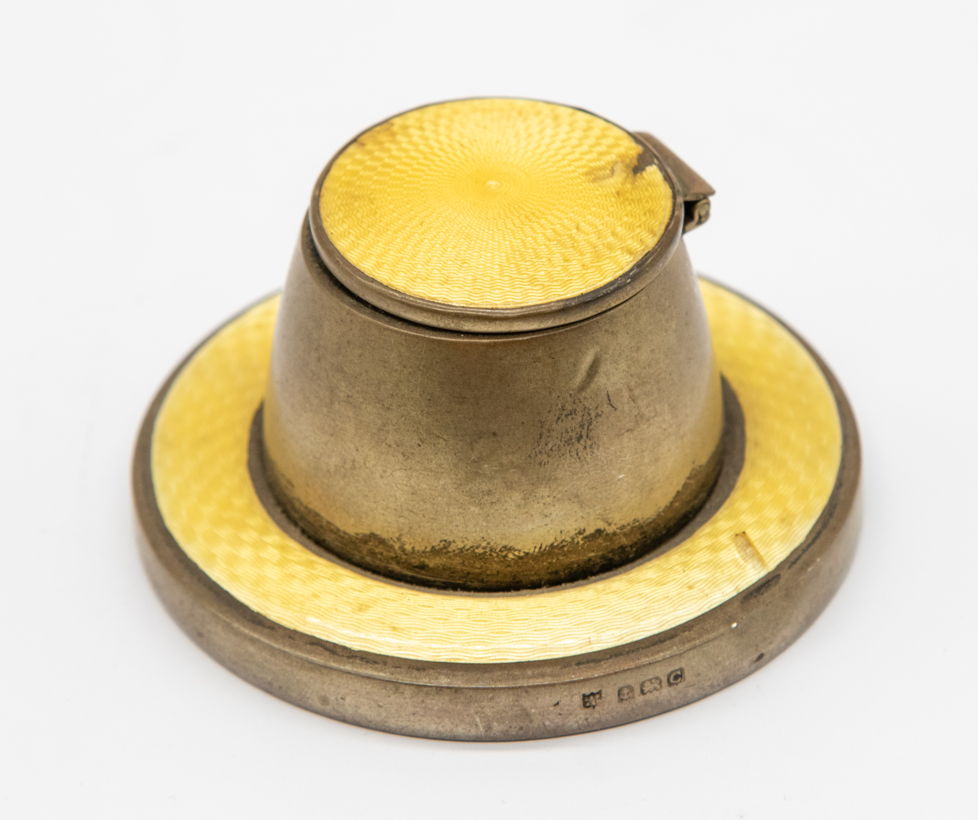A George V silver and yellow guilloche enamel ink well of stylish shape with circular base, hinged
