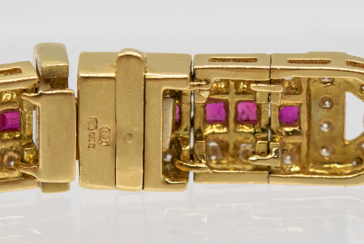 A ruby and diamond 18ct gold bracelet, comprising elongated panels, each set to the centre with a - Bild 5 aus 5