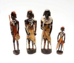 Four carved wooden Maasai tribe warrior figures.