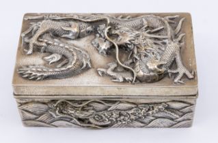 A Chinese silver cigarette box, with relief dragon design to top and all sides, slight planishing to