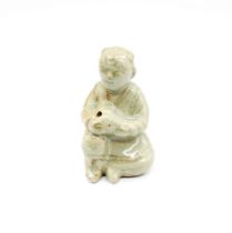 A celadon glazed stoneware human form water dropper with surface iron deposits, style of Goryeo