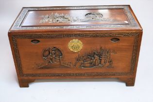 A 20th century Chinese hardwood coffer/bedding box, carved chinoiseries and figural design, inside