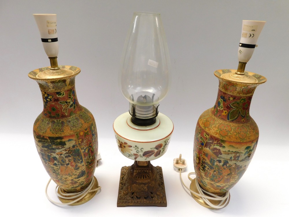 A pair of Japanese satsuma vases converted to lamps along with a late Victorian paraffin lamp with