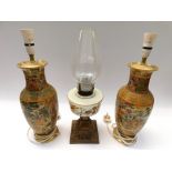 A pair of Japanese satsuma vases converted to lamps along with a late Victorian paraffin lamp with