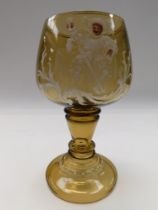 A late 19th Century German amber glass roemer, enamelled and printed with 17th Century seated man