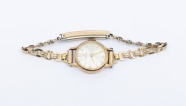 A ladies 9ct gold cased Tissot wristwatch, comprising a round silvered signed dial with applied gilt