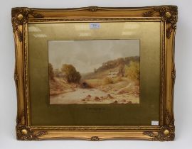 A pair of early 20th Century water colours in gilt frames of village and country scenes, signed
