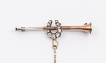 A diamond set rose and white metal brooch, modelled as a hunting horn, overlaid with a diamond set