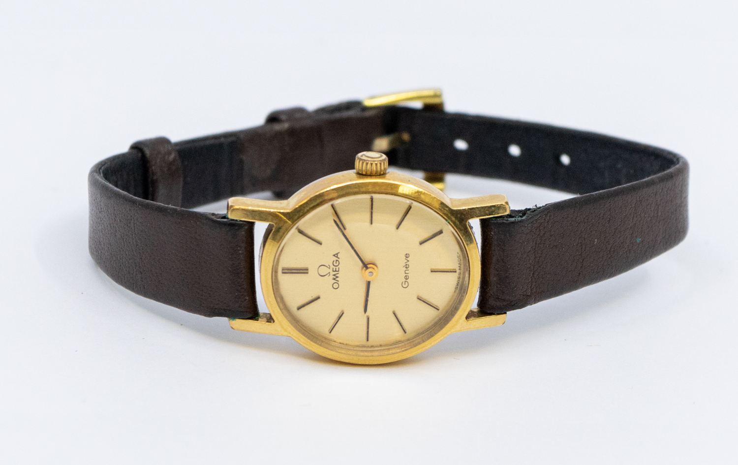 Omega- a ladies gold plated Omega Geneve wristwatch, comprising an oval gilt dial, baton markers,