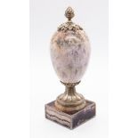 A Georgian style blue john ornamental urn, ovoid shaped body surmounted by gilt metal pineapple