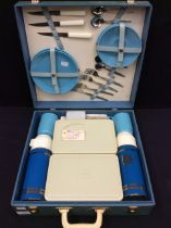 A 1960s complete picnic set in light blue carry case.