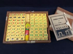 A 20th century cased Mahjong type Chinese game, plastic pieces, with original pamphlet for