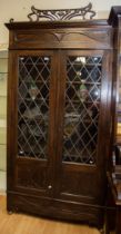Large Art Nouveau cabinet with leaded glazed doors with a stylised rose panel to each. Wooden