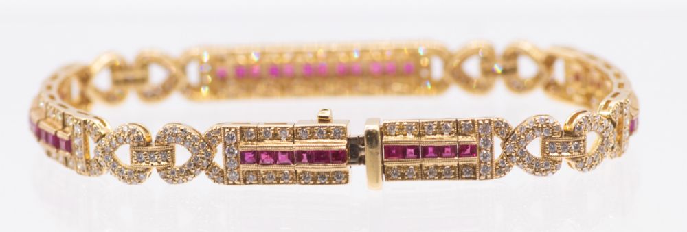 A ruby and diamond 18ct gold bracelet, comprising elongated panels, each set to the centre with a - Bild 2 aus 5