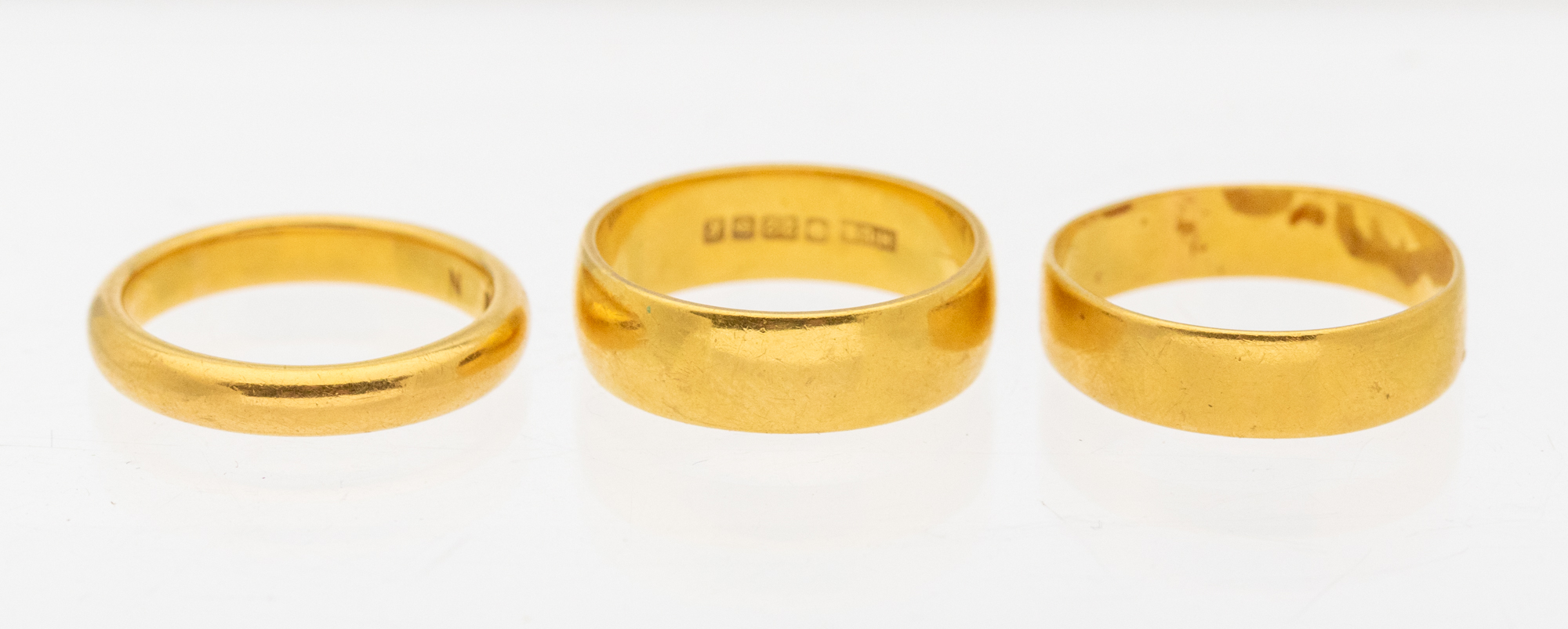 Three 22ct gold bands. various widths and sizes, weight approx 13.8gms  Further details: minor