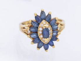 A large sapphire and diamond cluster ring, marquise shaped set to the centre with a marquise cut