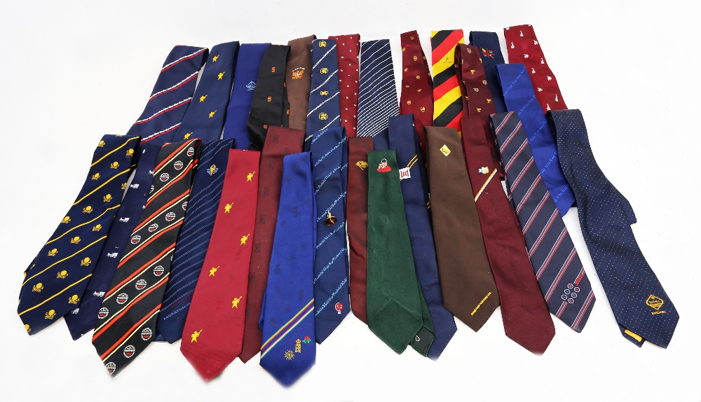 A large collection of ties to include one Guinness memorabilia, many with emblems on from clubs,