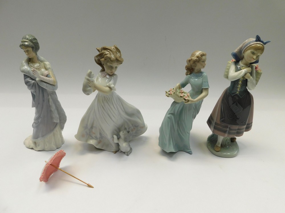 Four Lladro figures of young ladies, one with a parasol, parasol unattached but present