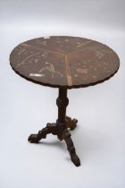 An antique Chinoiserie tilt-top table, having painted and inlaid decoration and on ebonised tripod