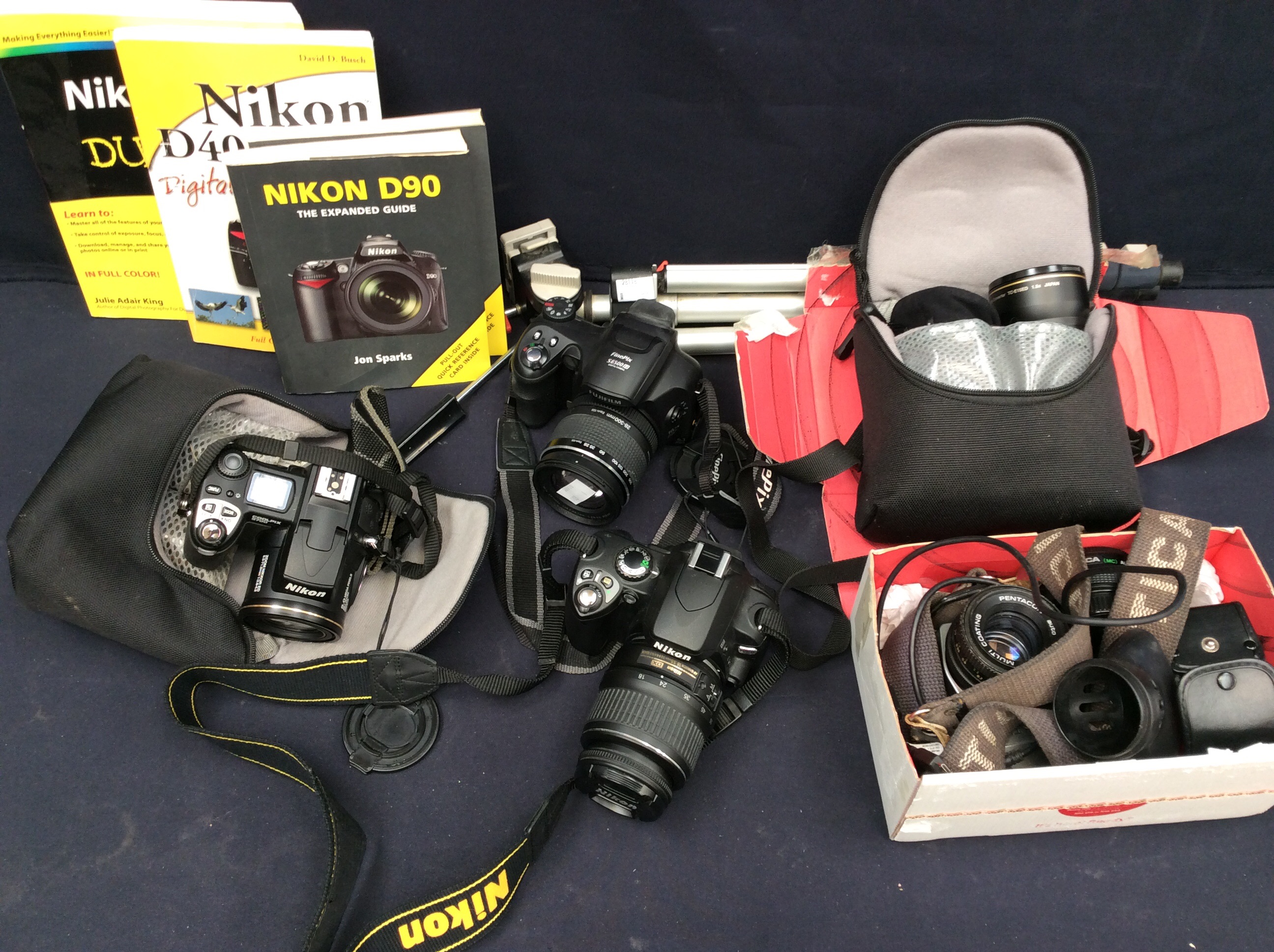 A collection of Nikon, Finepix and other cameras along with all accessories.