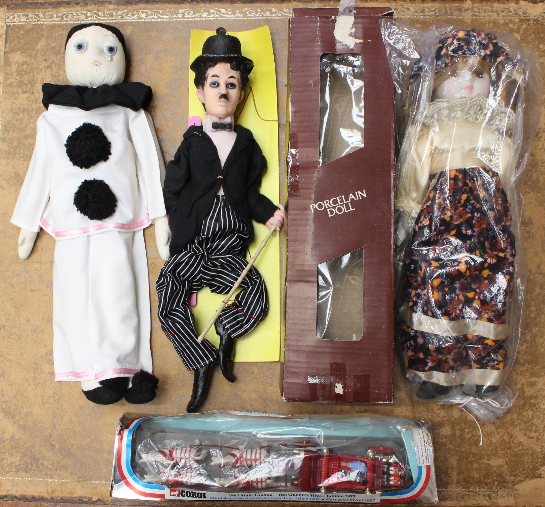 Toys: A collection of three assorted figures, included boxed porcelain doll, unboxed Pierrot doll,