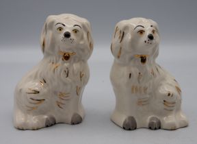 Two large Beswick King Charles Spaniels, two miniature versions, also by Beswick, along with two