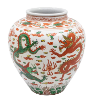 A Chinese ginger jar, enamelled with alternating green and red four claw dragons, six character