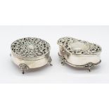 A George V silver circular ornate trinket box, hinged top with pierced foliage and floral design, on