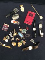 A mixed collection of vintage pin badges, watches, costume jewellery, yellow metal items etc.