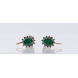 A pair of emerald and diamond 18ct gold cluster earrings, comprising an oval mixed cut emerald