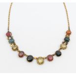 An early 20th century multi-gem harlequin gold set necklace, comprising various oval mixed cut