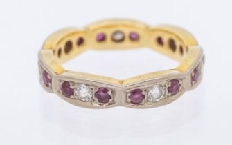 A ruby and diamond 18ct gold full eternity ring, scalloped design grain set with alternate round