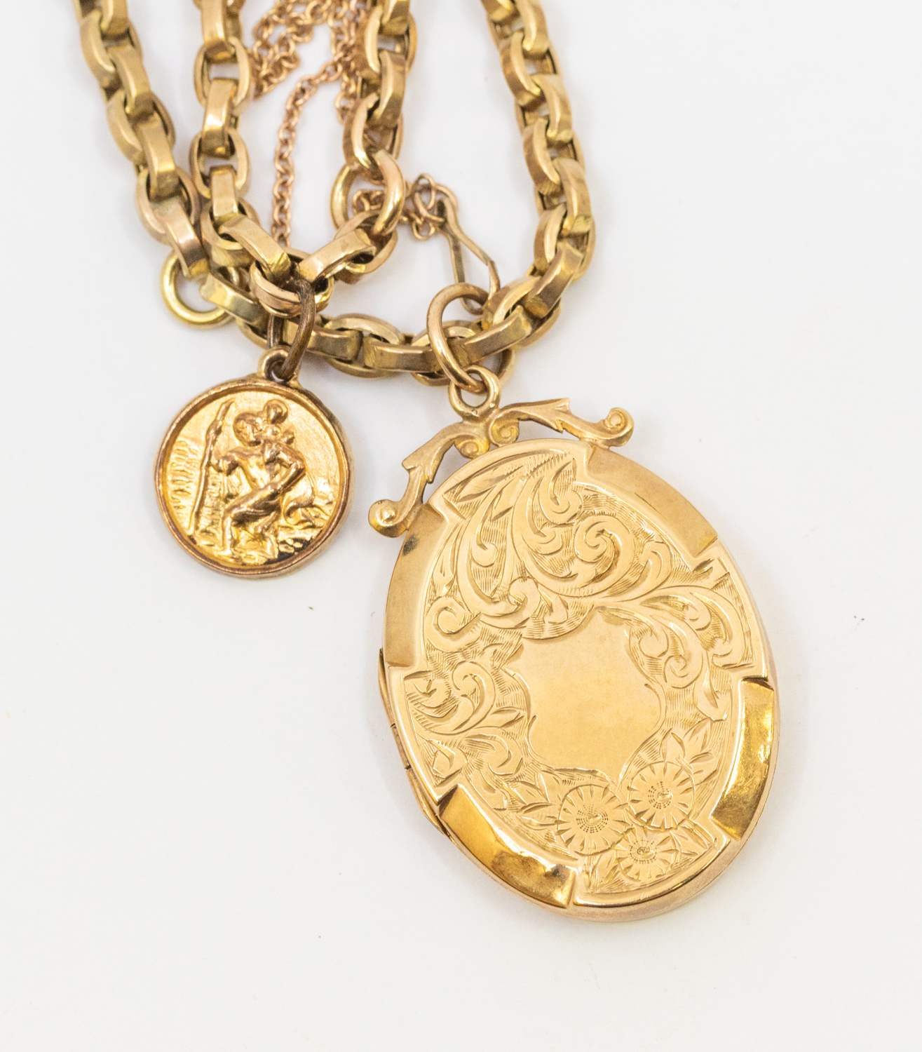 An unmarked yellow metal chain, assessed as 9ct gold suspending a small St Christopher and an oval - Image 2 of 2