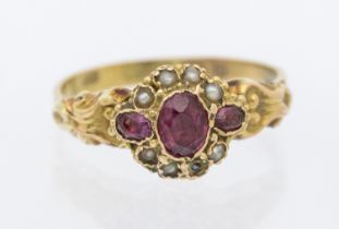 An early Victorian garnet and pearl set 12ct gold ring, floral motif set to the centre with an