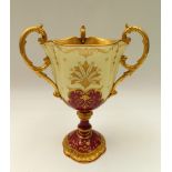 Coalport - A late 19th/early 20th century three handled trophy vase, ornate gilt interior with three
